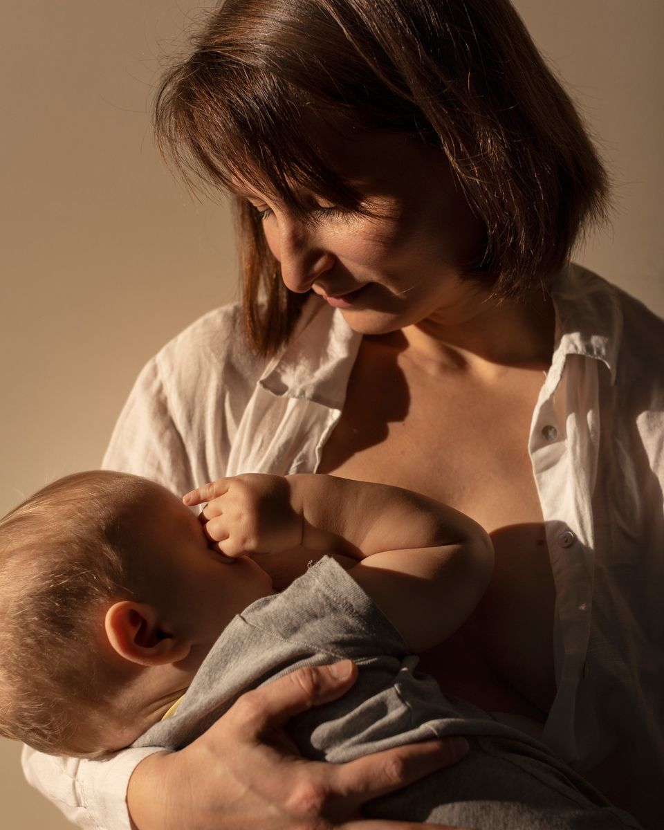 Madre amamantando a su bebé en brazos